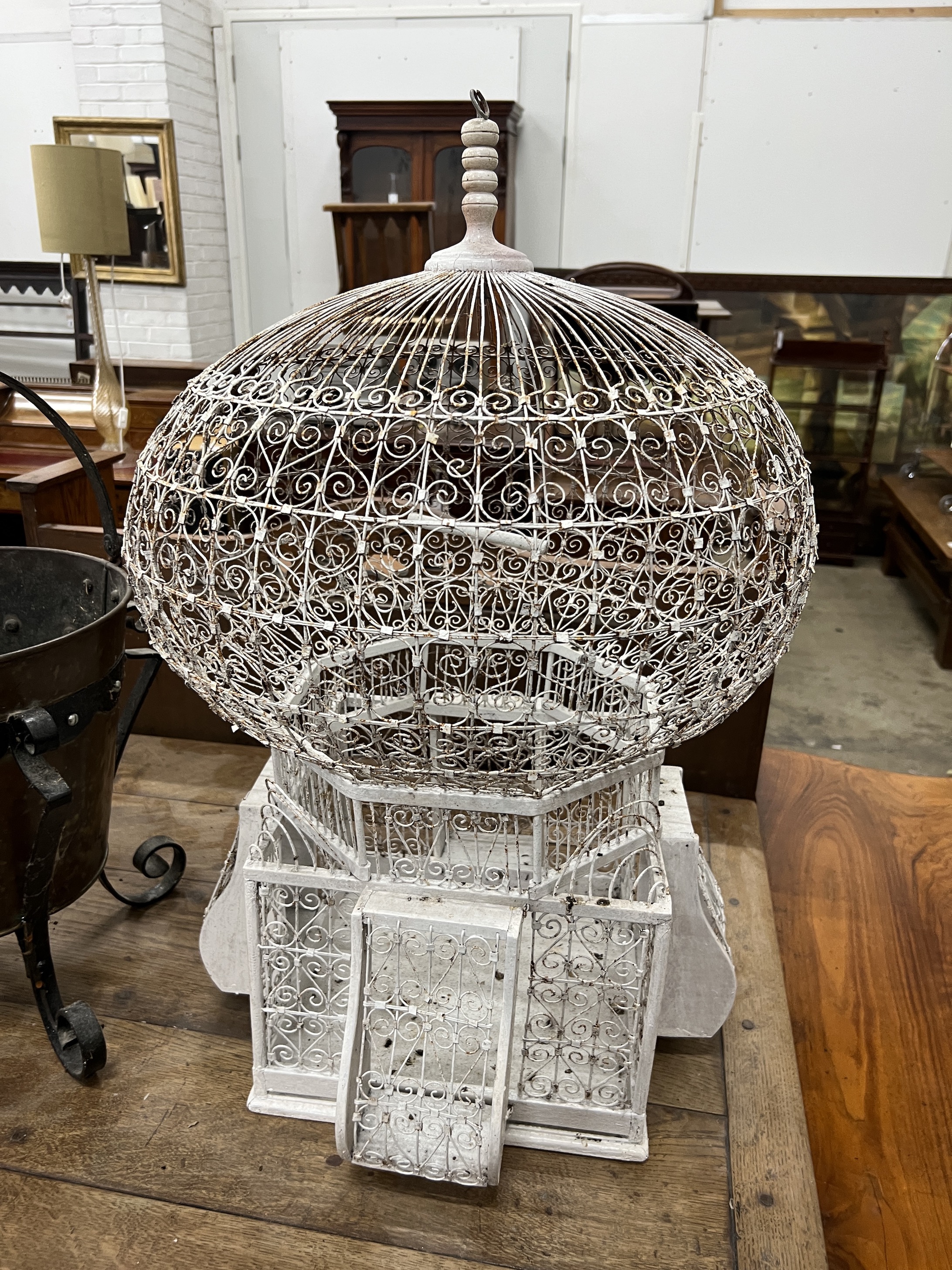 An early 20th century copper and wrought iron coal bucket, height 60cm, together with a wirework birdcage
